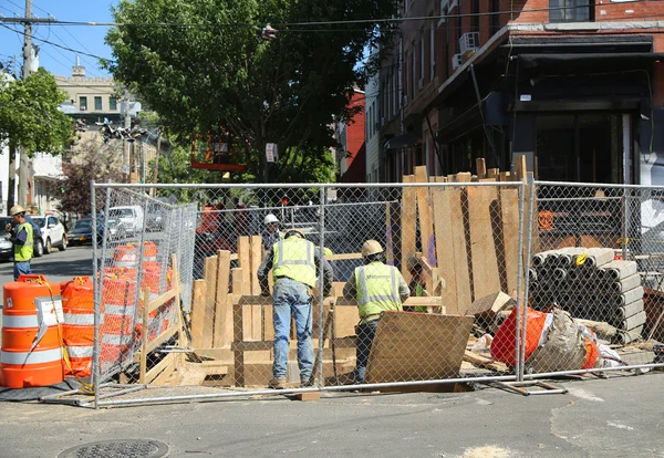 Constriction workers repair street in Brooklyn, New York