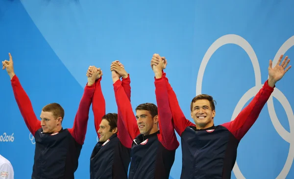USA Men\'s 4x100m medley relay team Ryan Murphy (L), Cory Miller,  Michael Phelps and Nathan Adrian celebrate victory at the Rio 2016 Olympic Games