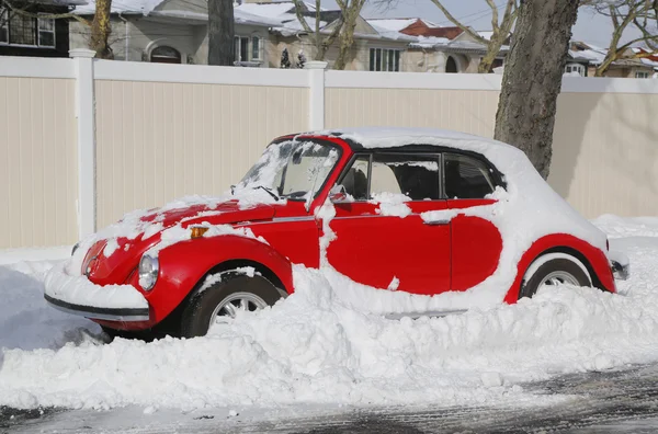 Car under snow in Brooklyn, NY after massive Winter Storm Juno strikes Northeast.