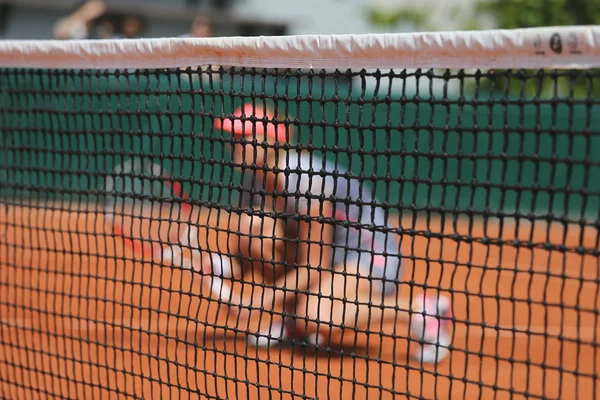 Tennis player at clay court during doubles match