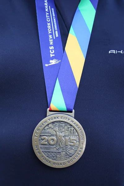 Unidentified 2015 New York City Marathon runner wears medal in Manhattan