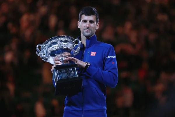 Grand Slam champion Novak Djokovic of Sebia holding Australian Open trophy during trophy presentation after victory at Australian Open 2016