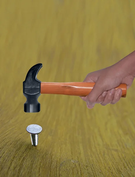 Hammer in Human Hand hitting a nail