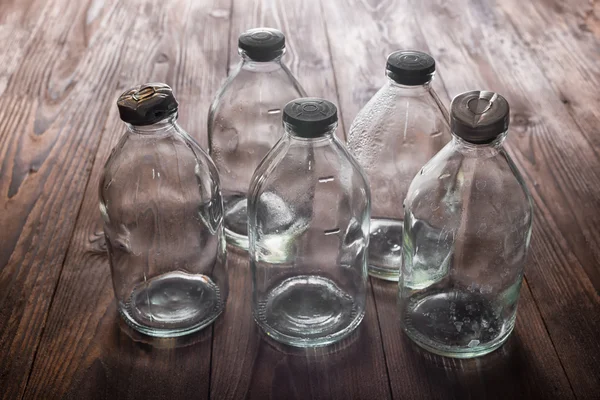Top view of dirty empty vintage transparent glass bottles with s