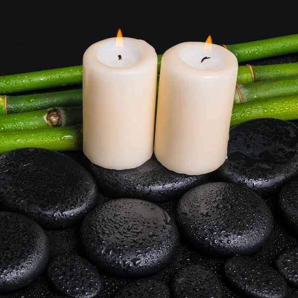 Spa concept of zen basalt stones,  candles and natural bamboo wi
