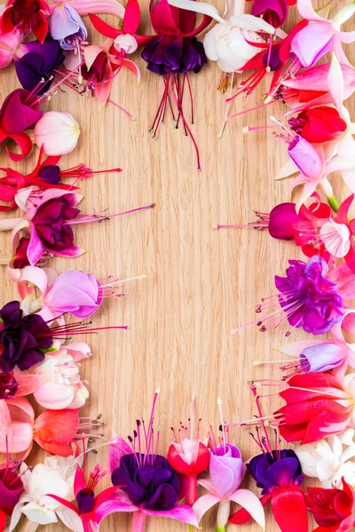 Fuchsia flower wreath with place for your text or image on woode