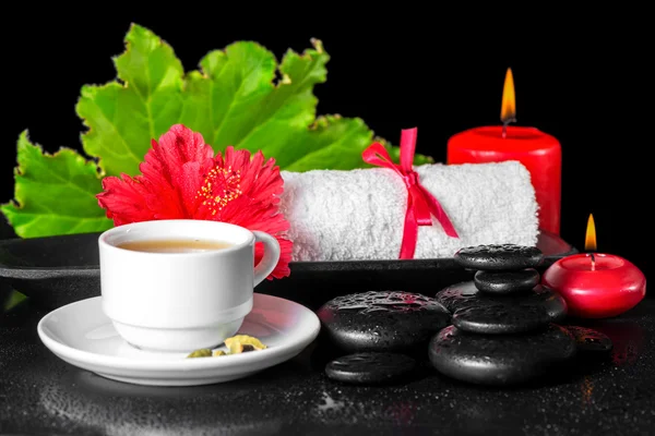 Beautiful spa concept of red hibiscus flower with dew, candles,