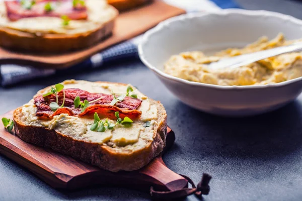 Spreads. Egg spread, grilled bacon, bread young basil leaves, Herb decoration. Ingredients: six eggs, spring onion, yeast, processed cheese, bacon, salt, pepper, various herbs decorations