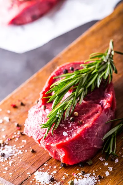 Steak. Raw beef steak. Fresh raw Sirloin beef steak sliced o Herb - Rosemary decoration