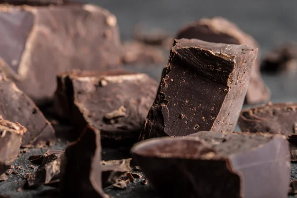 Chocolate. Black chocolate. A few cubes of black chocolate. Chocolate chunks. Chocolate bar pieces