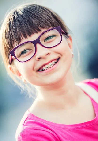 Girl. Teen. Pre teen. Girl with glasses. Girl with teeth braces. Young cute caucasian blond girl wearing teeth braces and glasses