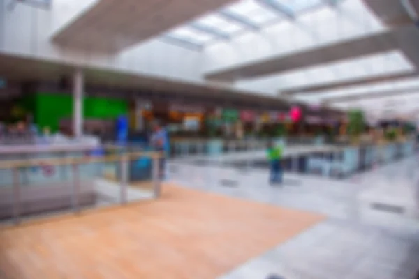 Blurred interior in shopping center. Shopping malls. Center passage in super market discount at the blur background