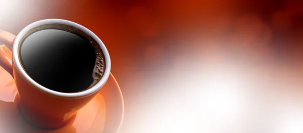 Cup of black coffee on bokeh background.  Banner of a cup of coffee