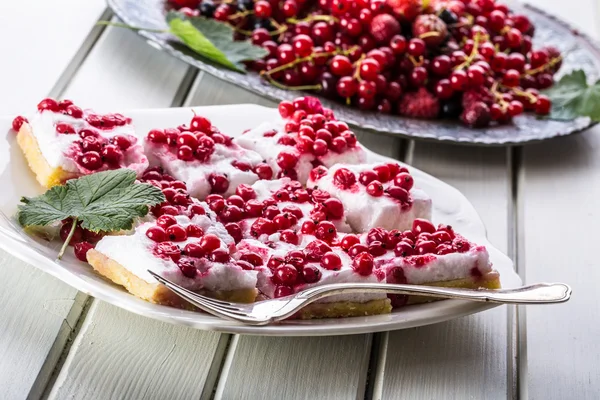 Red currant sponge cake. Plate with Assorted summer berries, raspberries, strawberries, cherries, currants, gooseberries.