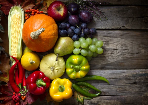 Autumn fruits and vegetables on vintage boards