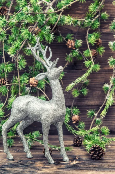 Christmas deer. Vintage style decoration with christmas tree bra