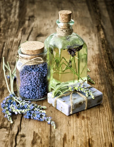 Massage oil, herbal soap and bath salt with fresh lavender flowe
