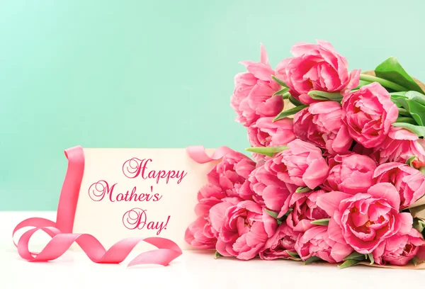 Pink tulips and greeting card. Happy Mothers Day