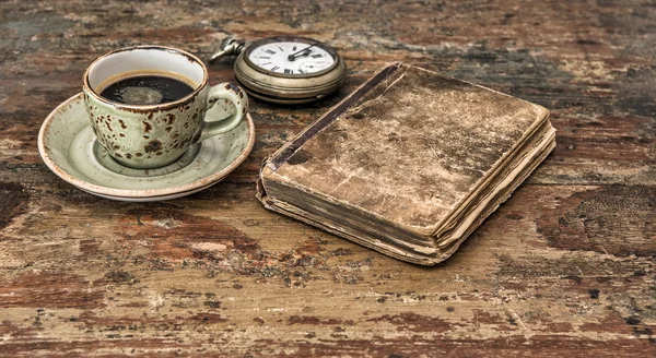 Cup of black coffee and antique book. Retro still life