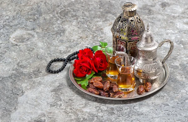 Tea and red rose flower, arabian lantern and rosary. Islamic hol