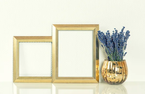Golden picture frame and lavender flowers. Vintage style mockup.