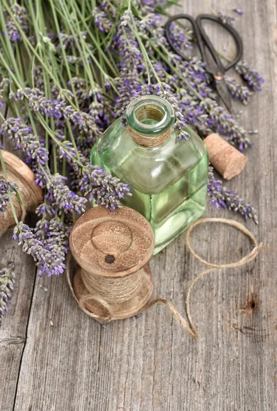 Lavender flowers bouquet with herbal oil and vintage tools
