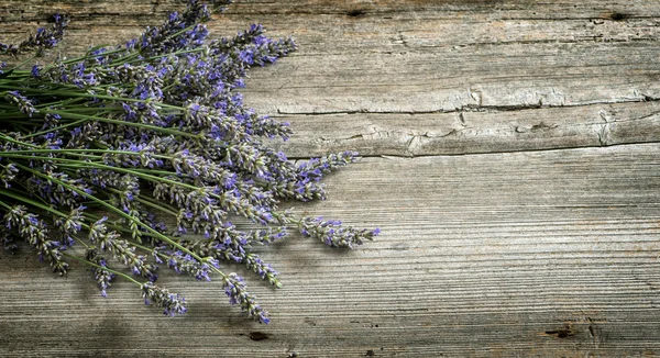 Lavender flowers on wooden background. Vintage style toned