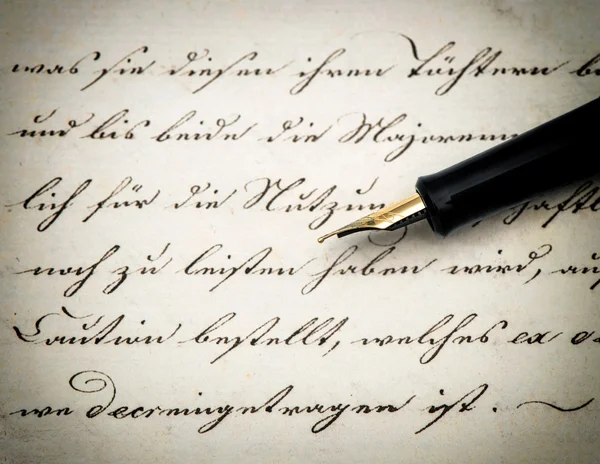 Calligraphic handwritten text and vintage ink pen. Retro style