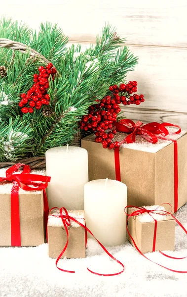 Christmas vintage decoration with white candles, gift boxes