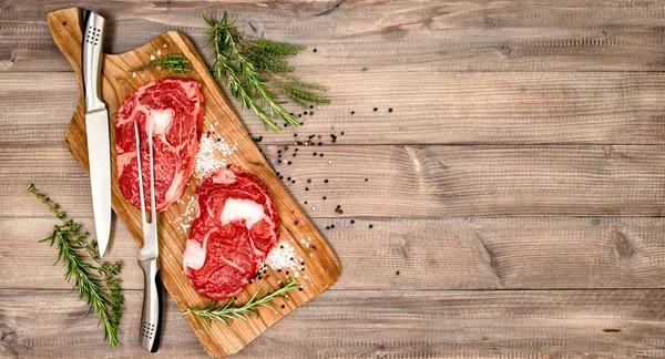 Rib Eye Steak with herbs and spices. Food background