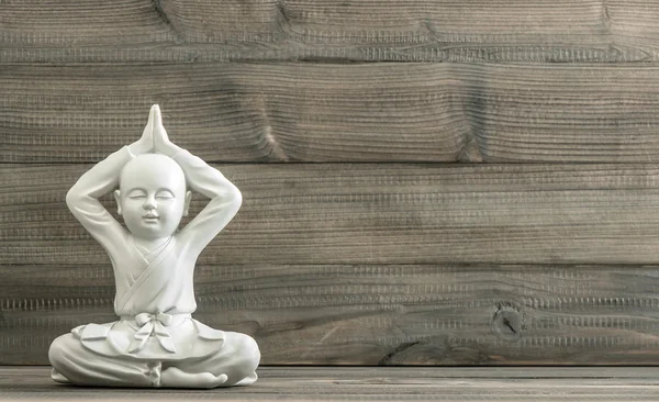 Sitting buddha. White monk statue. Meditation. Relaxing