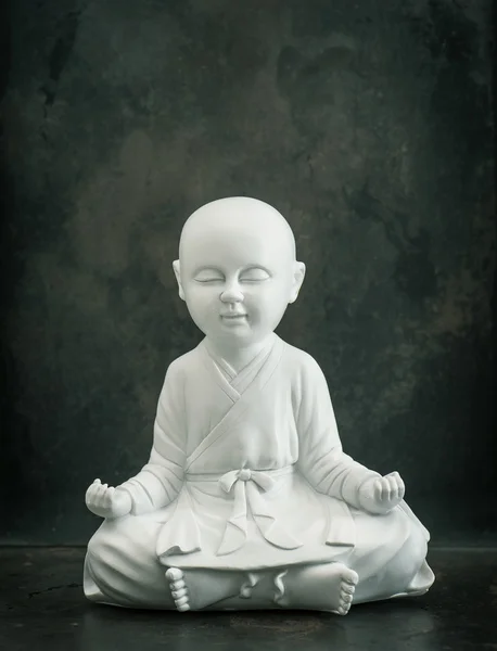 Praying buddha. White monk. Meditation. Relaxing. Vintage style