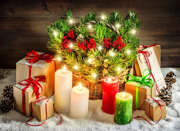 Christmas decoration burning candles and gift boxes lights