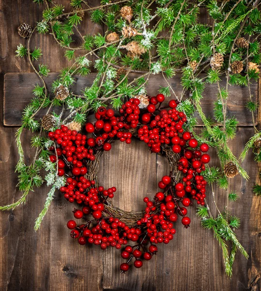 Christmas tree twigs and red berries wreath. Advent decoration