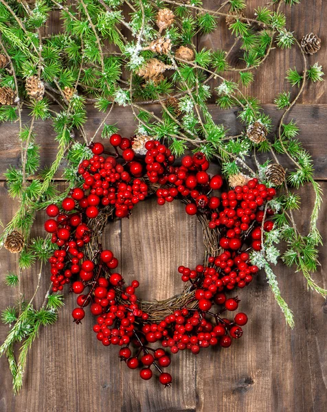 Christmas tree branches and red berries wreath decoration