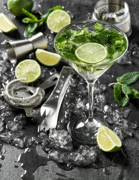 Cocktail drink with lime, mint, ice. Bar tolls ingredients