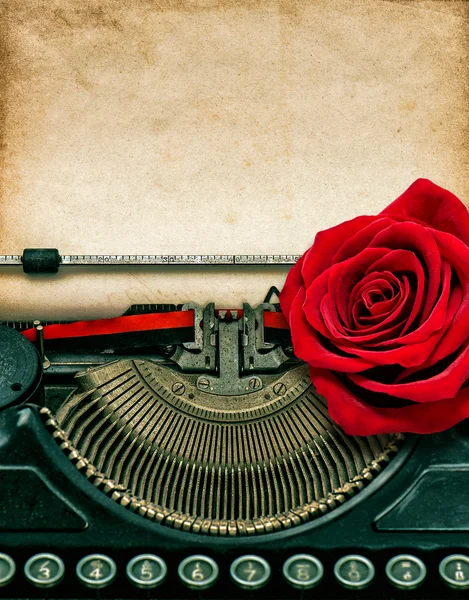 Vintage typewriter red rose flower. Grungy paper