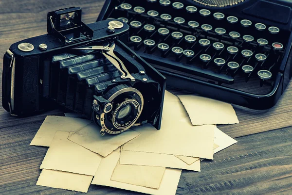 Vintage photo camera and typewriter. Retro toned