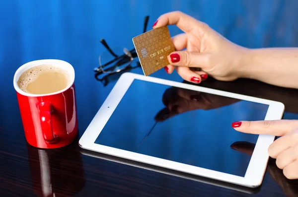 Woman using tablet pc and credit card indoor, Shopping online