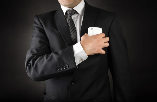 Business man taking the smartphone out of his pocket