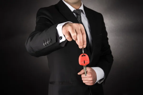 Businessman giving a car key