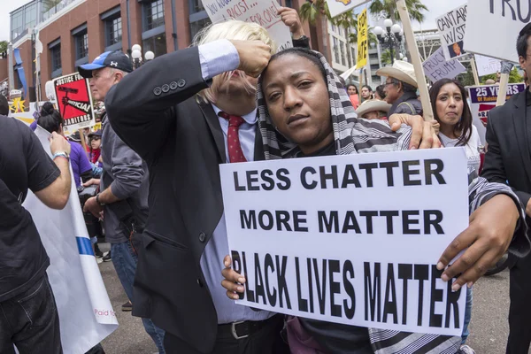 Anti-Trump protester with Black Lives Matter sign