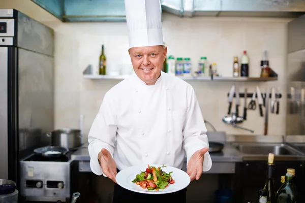 Chef with vegetable salad