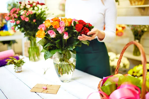 Florist standing near bouquet