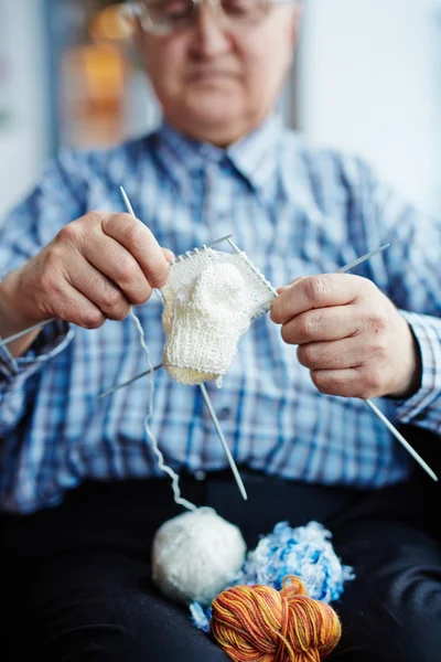 Man knitting sock