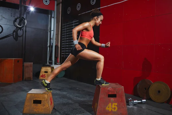 Woman training on jump-boxes
