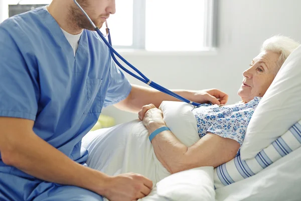 Senior woman lying in bed