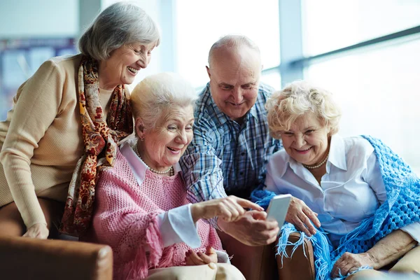 Friendly seniors with smartphone