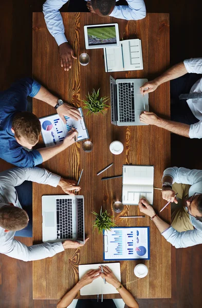 Business people gathered by table