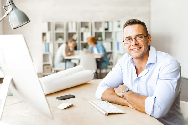 Young specialist sitting at workplace in office